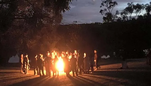 Retreat group around a fire at night